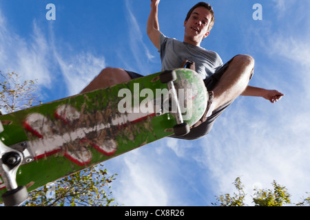 Young man jumping on a skateboard - USA Stock Photo