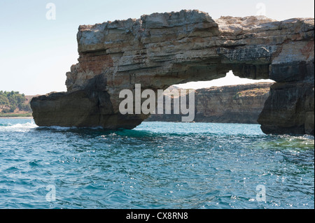 Natural limestone arch in the sea, Crete Greece Stock Photo