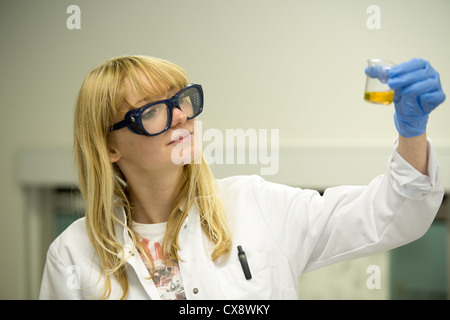 Young woman preparing solutions in laboratory Stock Photo