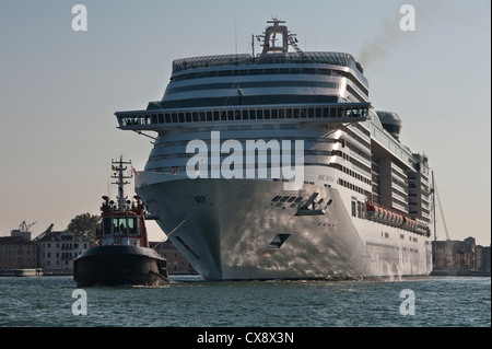 A huge cruise ship, the MSC Divina, is towed through Venice, Italy. It is owned by MSC Cruises and has a gross tonnage of 139,400 Stock Photo