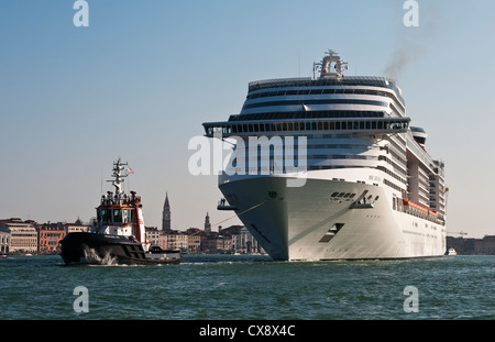 A huge cruise ship, the MSC Divina, is towed through Venice, Italy. It is owned by MSC Cruises and has a gross tonnage of 139,400 Stock Photo