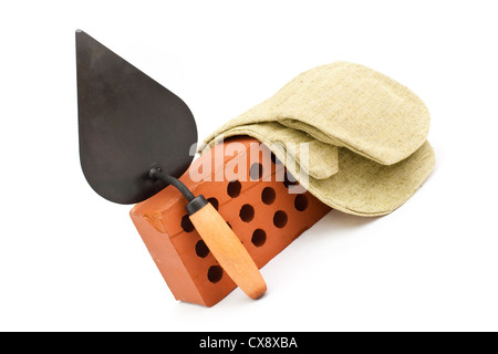 Red perforated ceramic brick, trowel and gauntlet isolated on white Stock Photo