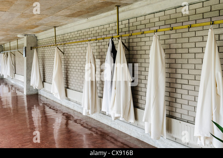 Monastic robes for monks in a monastery hanging on a wall Stock Photo