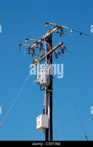 Power line pole Electrical transformers mounted on a power line pole. Also visible are ceramic insulators. California, USA. Stock Photo