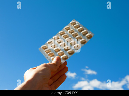 A full sheet of tablets held up to the sky Stock Photo