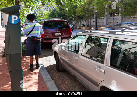 A parking enforcement officer writing a ticket - Washington, DC USA Stock Photo