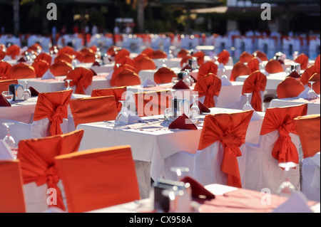 long lines of festively decorated tables and with red bows chairs Stock Photo