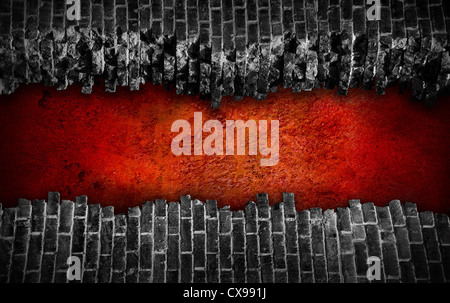 Broken black brick wall with large red hole Stock Photo