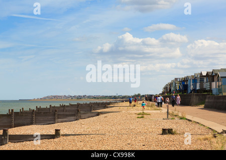 Whitstable seafront promenade along Saxon Shore Way with beach huts and shingle beach in Tankerton Bay on north Kent coast Whitstable England UK Stock Photo