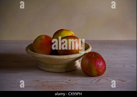 Bowl of apples lit by a soft window light. Stock Photo