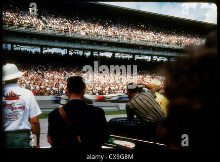 Indy 500 Indianapolis 1962 race car motor speedway 1960s racing sports racing stands crowd fast speed passing pass pit row Stock Photo