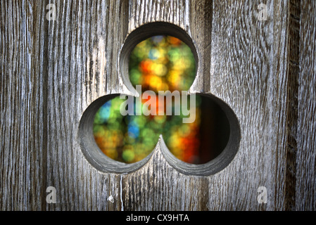 Stained glass window seen through chapel door at Puerto Ibaneta in Spain. Stock Photo