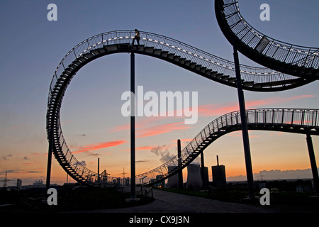 The walkable, rollercoaster shaped sculpture Tiger & Turtle – Magic Mountain and power plant in Duisburg, Germany Stock Photo