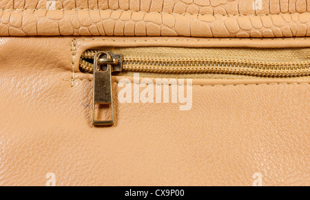 Closeup copper zipper of brown handbag leather Stock Photo