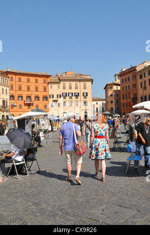 Rome, Italy - 29 March, 2012: Tourists walking in Piazza Navona, major touristic landmark in the historical centre of Rome Stock Photo