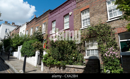 Georgian terraced housing with roses in bloom and front gardens and homes on Back Lane, Hampstead Village, London England UK Stock Photo