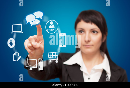 Businesswoman pressing high tech type of modern buttons on a virtual background Stock Photo
