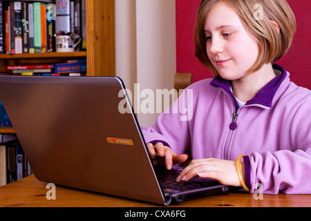 Ten year old girl using a laptop computer Stock Photo