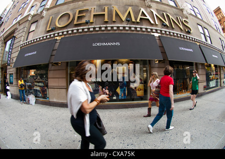 Shoppers enter and leave a Loehmann's department store in New York on Thursday, September 13, 2012. (© Frances M. Roberts) Stock Photo