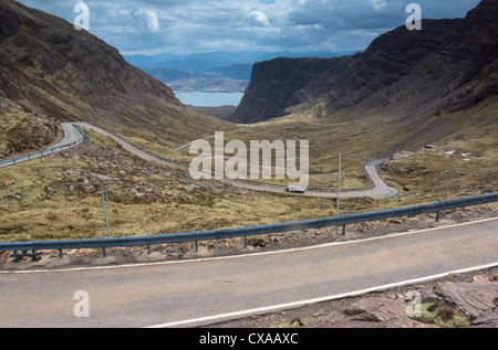 A car descending the twisty road that leads down Bealach na Ba, Scottish Highlands. Stock Photo