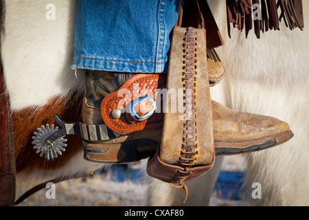 Boot with spurs in stirrup on ranch in eastern Wyoming Stock Photo