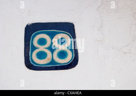 number 88 on house wall in santorini, greece Stock Photo