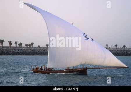 Abu Dhabi, United Arab Emirates, traditional racing Dhow approaching the breakwater in Abu Dhabi. Stock Photo