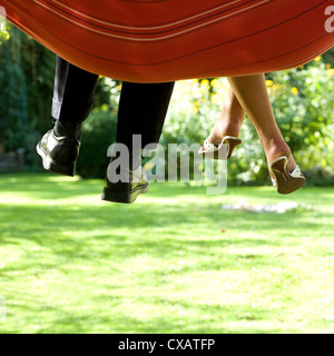 Berlin, legs dangling from the hammock Stock Photo
