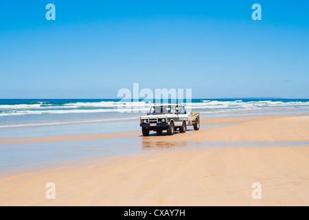 Tourists driving on Seventy Five Mile Beach on a self drive 4x4 tour of Fraser Island, Queensland, Australia Stock Photo