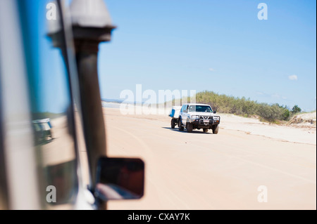 Tourists driving on Seventy Five Mile Beach on a self drive 4x4 tour of Fraser Island, Queensland, Australia Stock Photo