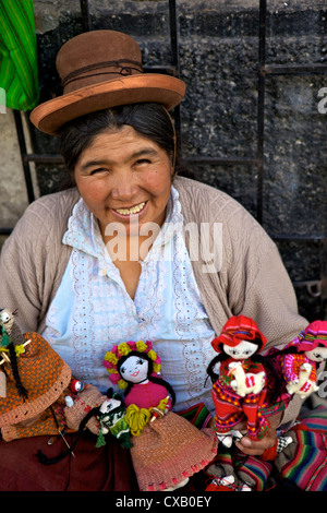 Indigenous lady selling dolls, Arequipa, Peru, South America Stock Photo