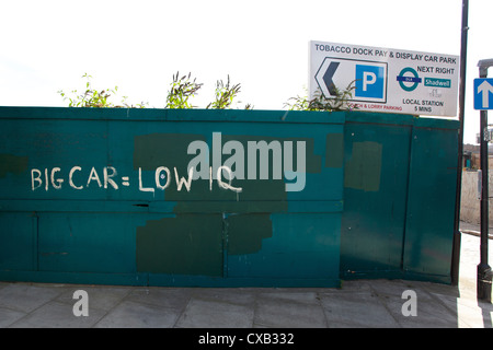BIG CAR = LOW IQ painted on wooden boards, The Highway, Wapping, London, England, UK. Stock Photo