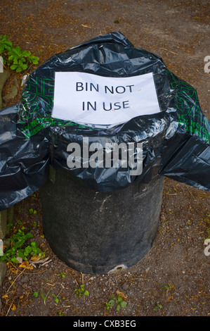 Rubbish bin not in use covered with black plastic bag Stock Photo