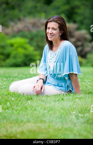 Pretty brunette adult woman portrait smiling outside Stock Photo