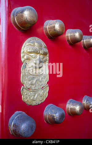 Traditional red ornate door at entrance to temple in Beijing China Stock Photo