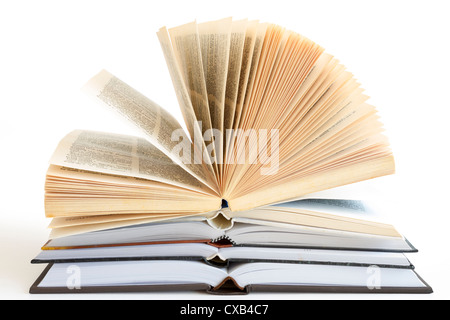 Stack of open old fanned hardcover leather bound books Stock Photo