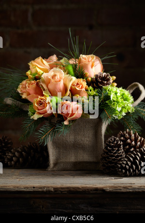 Rose, Hydrangea, Hypericum, Douglas Fir and Pine Flower Arrangement Stock Photo