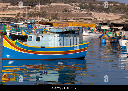 Colourful traditional luzzu fishing boats Marsaxlokk harbour Malta Stock Photo