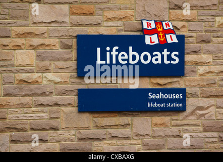 An RNLI Lifeboat sign on the side of the lifeboat station at Seahouses, Northumberland. Stock Photo