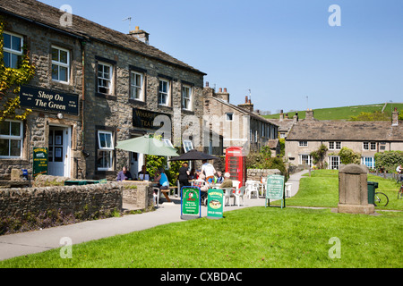 People sitting outside a tea shop on the Village Green in Burnsall, Wharfedale, Yorkshire Dales, Yorkshire, England Stock Photo