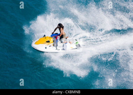 Man on a jet ski, Nassau harbor, New Providence Island, Bahamas, West Indies, Central America Stock Photo