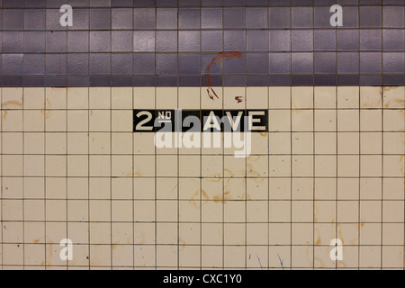 Sign on the tiled wall in Manhattan's 2nd AVE station announcing the stop. Stock Photo