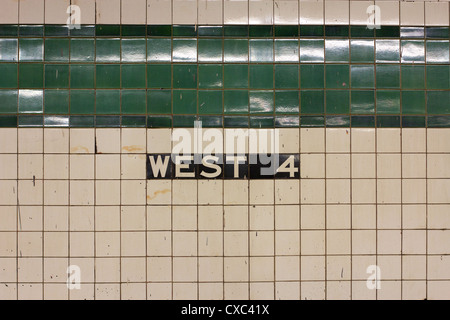 Sign on the tiled wall in Manhattan's WEST 4 station announcing the stop. Stock Photo