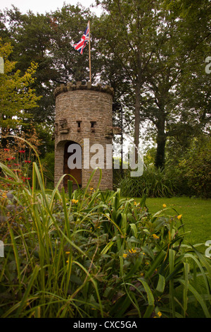 Stone tower with water feature and dove coot and water spouting gargoyles, Westonbury Mill water gardens, Pembridge, Herefordshi Stock Photo
