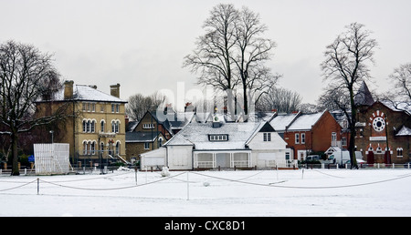 Snow covering the cricket pitch and pavilion on Twickenham Green, Greater London, UK Stock Photo