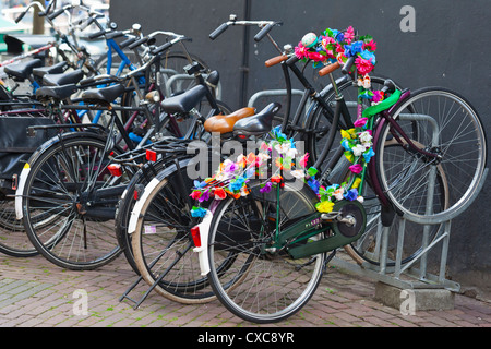 Amsterdam: Flower decorated bicycle - Amsterdam, Netherlands, Europe Stock Photo