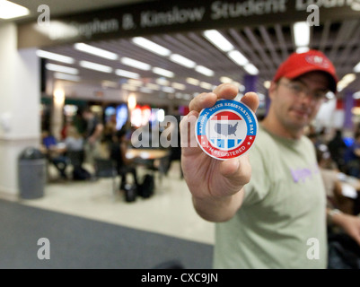 White male holds up sticker showing he was registered to vote on National Voter Registration Day Stock Photo