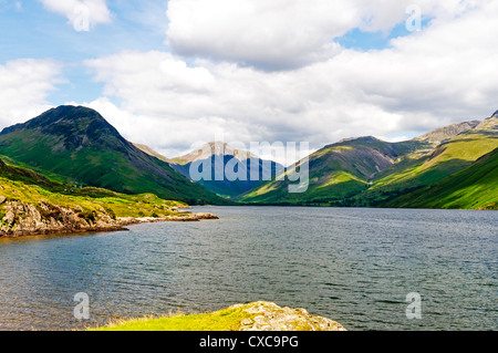 The view from the south-western end takes in the lake with the mountains of Yewbarrow, Great Gable and Lingmell behind. Stock Photo