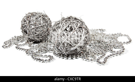 Two wicker balls and silver beads on white background Stock Photo