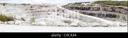 Tatlock Quarry panorama a study in White. A large mining truck enters a huge open pit mine of white quarzite marble. Stock Photo
